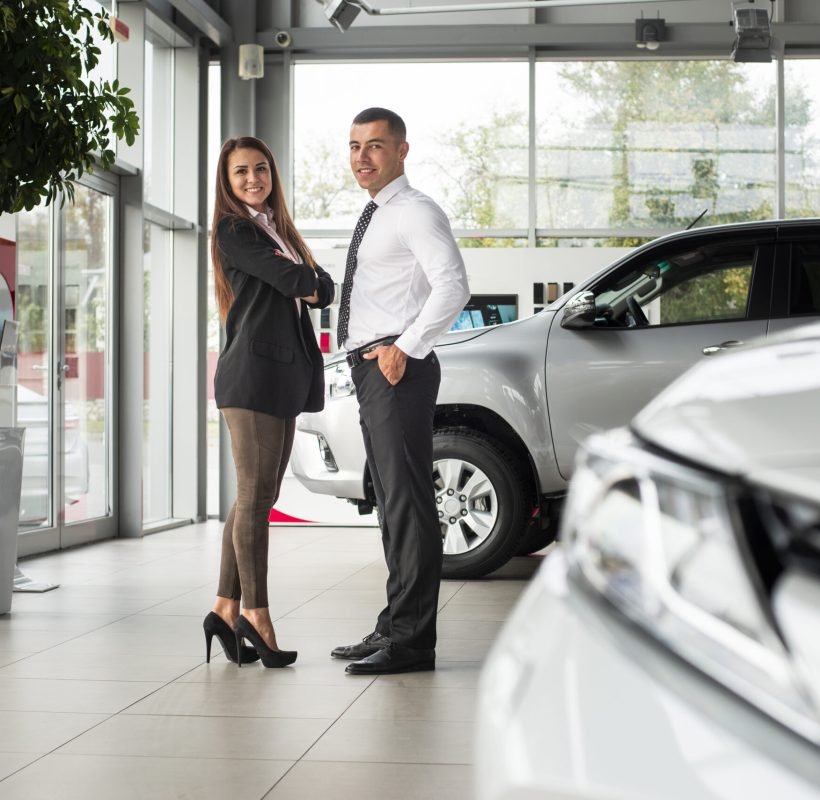 man-woman-together-car-dealership