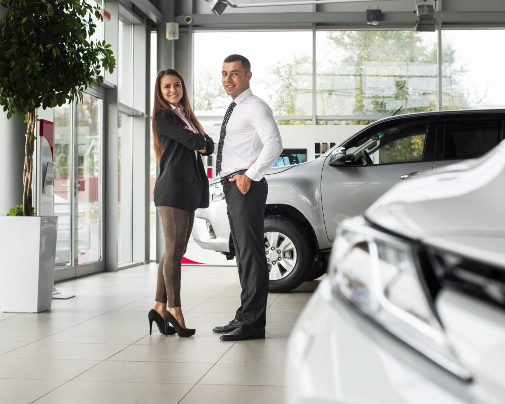 man-woman-together-car-dealership